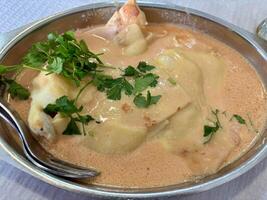 Creamy sauce dish with herbs photo
