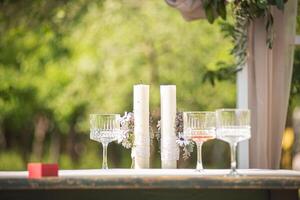 Candle and glass centerpiece on table photo