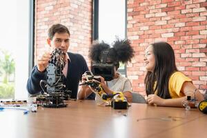 Diverse Kids and Teacher Exploring Robotics and VR Technology, Children Learning STEM with Virtual Reality and Robot Kits, Teacher Guiding Students in Modern Tech and Engineering Class photo