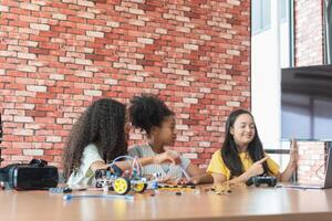 Children Learning Robotics, Young Girls Engaged in Robotics and STEM Learning, Diverse Kids Building a Robot Arm in a Science Workshop, Girls Exploring Technology and Innovation photo