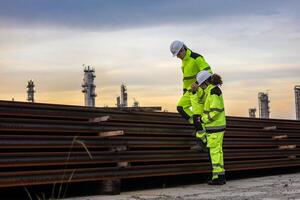 Construction workers inspecting steel beams photo