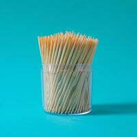 Group of toothpicks made of bamboo in a cup on background. photo