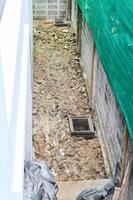 High angle view of messy passage during major house renovation. dug up ground and rubble show demanding process of home improvement and exterior construction work photo