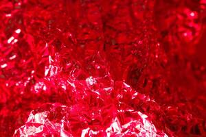 Vibrant red metallic foil texture creating a striking visual detail in an artistic display photo