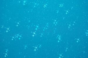 Glittering blue background filled with shining stars creates a dreamy and enchanting atmosphere suitable for various projects photo