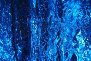 Bright blue metallic foil creating an abstract texture in a vibrant composition photo