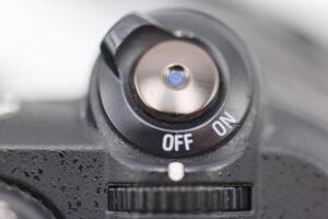 Camera power switch in close up showing off and on positions for photography equipment usage photo