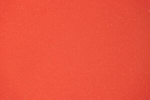 Bright orange textured surface with shimmering particles creating a vibrant aesthetic appeal for design or art projects photo