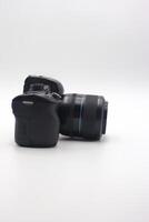 Compact digital camera with lens positioned on a white background showcasing design details and features for photography enthusiasts photo
