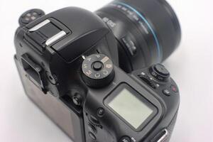 Detailed view of a professional camera featuring settings dial and lens highlighting photography equipment photo