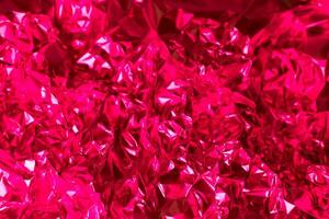 Bright red crumpled foil creates a vibrant texture reminiscent of shimmering fabric or artistic decor elements in a playful setting photo
