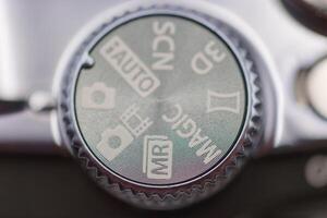 Settings dial on a camera showing various modes during a photography session photo