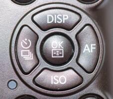 Camera control button layout featuring key functions like display, autofocus, and ISO settings for photography enthusiasts photo