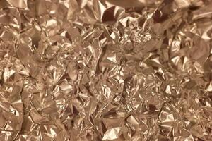 Crumpled metallic foil provides an abstract and textured background for creative projects and design photo