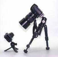 Camera equipment setup features a large DSLR camera and a compact digital camera in a studio environment photo