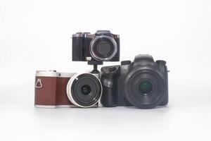 Various cameras arranged creatively on a white background showcasing different styles and sizes in photography equipment photo