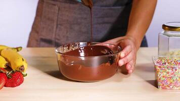 Mixing chocolate with spatula, fruits, and sprinkles video