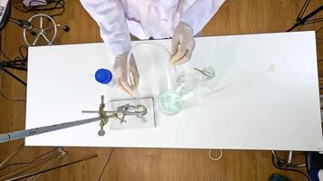A scientist conducts a thermal decomposition experiment with copper carbonate, showcasing chemical reactions and laboratory techniques video