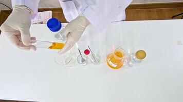 Scientist conducts a colorful chemistry experiment using bromothymol blue in a well-lit laboratory setting video