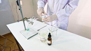 A scientist conducts a chemical reaction between copper carbonate and sulfuric acid in a laboratory setting video