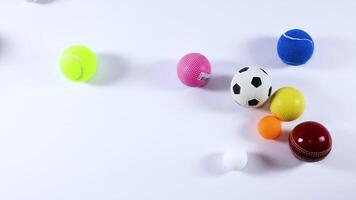 Various balls moving across a white background video