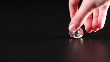Hand spinning a top on a surface video
