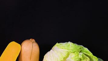 Assorted vegetables displayed against a dark backdrop video