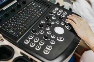 Concept medical imaging. Close-up of ultrasound machine as medical worker performs scan. photo