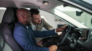 The concept of a confidential dialogue between the buyer and the consultant, the process of making a decision to buy a car. Consultation with the seller when buying a new car. photo