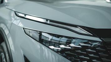 Close-up of car headlights in an automobile showroom. An advanced design concept that improves visibility, demonstrates innovation and adds style to nighttime driving photo