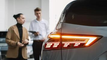 Consultation with the seller when buying or renting a new car. The concept of a confidential dialogue between the buyer and the consultant, the process of making a decision to buy a car photo
