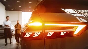 A dealer advises a client on purchasing a modern car at a car dealership. The concept of purchasing, renting and test-driving a new modern car. photo