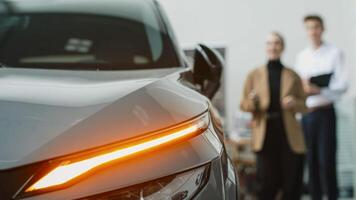 Consultation with the seller when buying or renting a new car. The concept of buying or renting a new car from a car dealership. photo