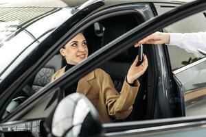 The completion of a car purchase or rental deal, with the handover of keys. Concept the final step of a seamless car buying, selling, or test-driving experience, highlighting customer satisfaction. photo