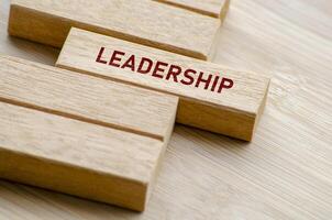Leadership words arranged on wooden blocks, reminding us of the principles and practices that define a great leader in any professional setting photo