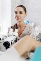 Concept of detailed medical examination. Gynecologist performs colposcopic examination. photo
