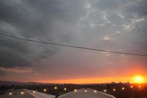 A blurry picture of a beautiful sunset with umbrellas in front photo