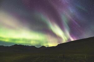 Emerald waves swirl above towering summits. photo