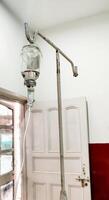 Medical IV Drip Hanging on Stand in Hospital photo