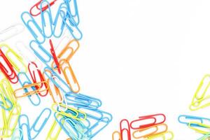 Colorful Paper Clips Scattered on a White Background Creating a Vibrant Visual photo