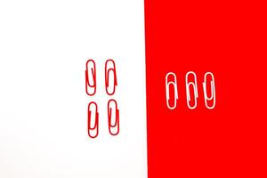 Paper clips in contrasting colors against a vibrant two-tone background create a striking visual effect photo