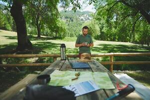 Young Man Camping in Scenic Green Forest, Exploring Nature and Adventure photo