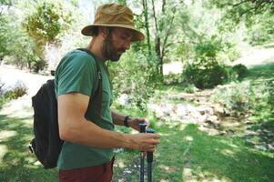Traveler Hiking in Nature by a Stream on a Sunny Summer Day photo