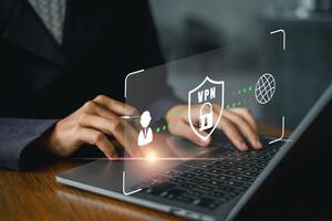 Hands typing on a laptop with a digital VPN shield icon, symbolizing online security, privacy, and data protection. photo