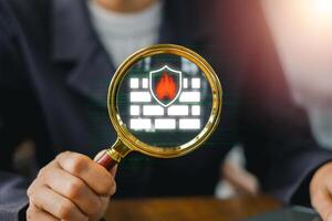 Digital representation of a firewall with a shield and magnifying glass, symbolizing cybersecurity and network protection. photo