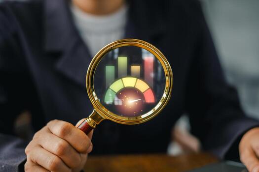 A business professional examines a benchmark concept using a magnifying glass, highlighting colorful bar graphs for data analysis. photo