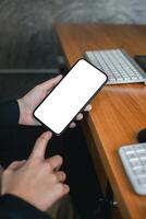 Close-up of a person holding a smartphone with a blank screen, ideal for mockups or design presentations. photo