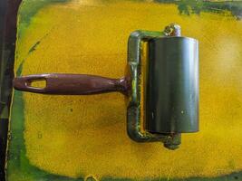 detail of yellow color swab old printing press machine photo