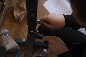 Man assembling fitness equipment at home preparing a gym for daily exercise and healthy lifestyle routines. photo
