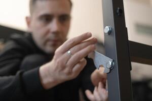 Home repairman fixing and assembling furniture using professional tools and skills for a neat and durable result. photo